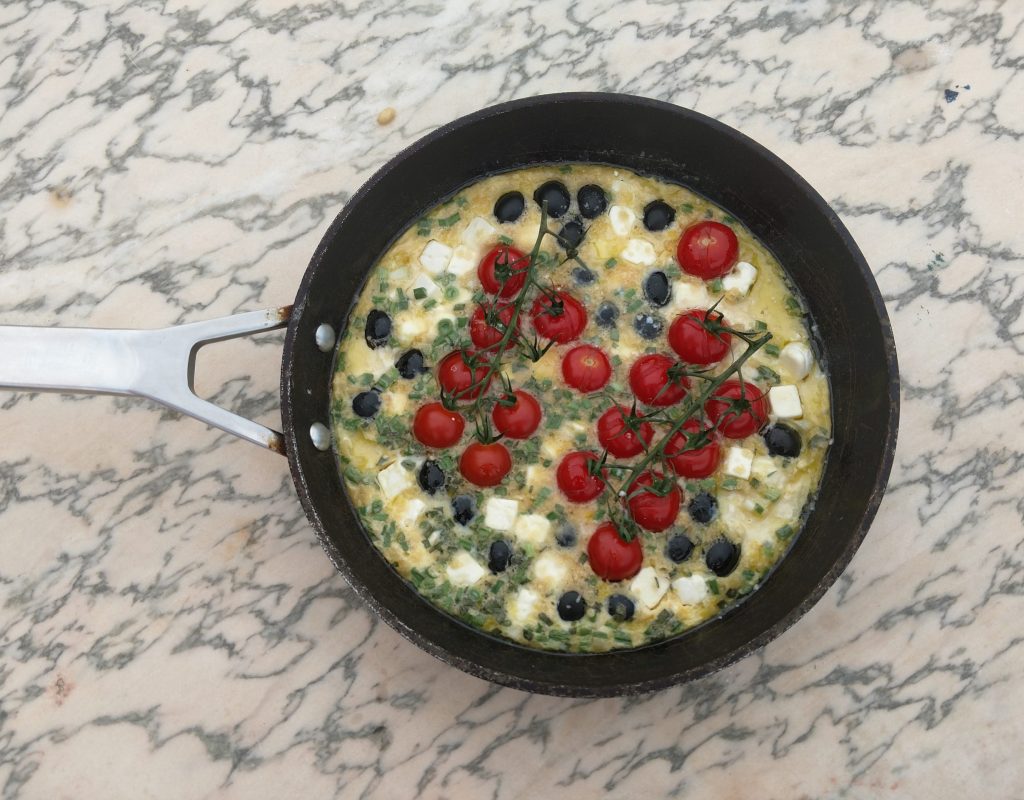 Ensalada caliente de queso feta, tomates cherries y aceitunas negras